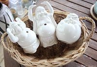 Three Buddha bottles in wicker basket