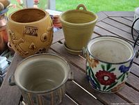 All four ceramic pots on table