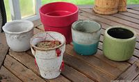 Front view of five assorted glazed pots showing colours and general condition