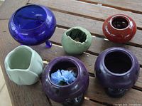 All six pots arranged on wooden surface