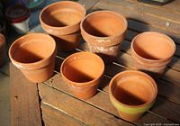 Six terracotta pots upright showing interior condition