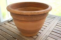 Exterior view of thick terracotta planter showing geometric band and rim