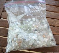 Full view of sealed bag filled with glass cabochons