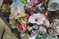 Top view of mixed artificial flower bundle showing variety of blooms and colors