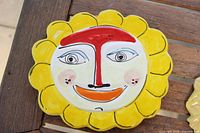 Front of multicolour sun plaque showing painted details