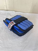 Folded blue/black All Pro weighted wrap showing logo and strap