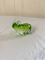 Front three-quarter view of green-clear glass frog