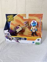 Front of sealed box showing figure, speeder, lightsaber