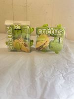 Front view of two sealed Joie cactus taco holder boxes