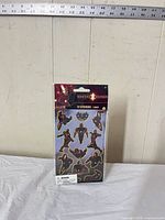 Front view of sealed Iron Man sticker sheet showing 12 metallic stickers