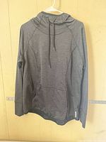 Front view of charcoal gray Reebok pullover hoodie showing drawstring hood and kangaroo pocket