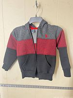 Front view of kids size 7 U.S. Polo Assn. color-block hoodie on hanger