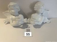 Both cherub candle holder figurines front view