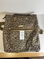 Front view of Anne Klein leopard print bag showing exterior condition and front zipper pocket