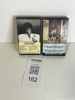 Front view of both 8-track cartridges showing artwork and titles