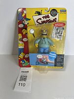 Front view of sealed Grampa Simpson action figure on card
