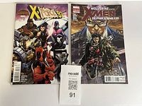 Both comic books side by side with lot ticket