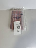 sealed wallet front with label and lot tag visible