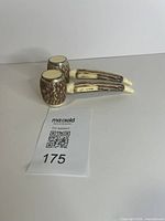Two pipe-shaped shakers with MaxSold lot card