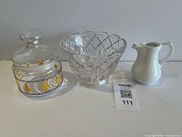 All three items: glass cookie jar, cut glass bowl, white creamer