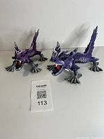 Two purple dragon sculptures, frontal angle