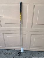 Full view of hybrid golf club from grip to head