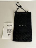 Front view showing GUESS logo and monogram texture