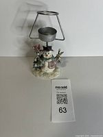 Front view of snowman tealight holder with metal frame