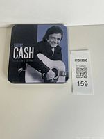 Front view of Johnny Cash Collector's Edition metal tin with artist image