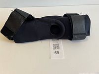 Full view of black knee brace laid flat