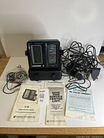 Complete lot layout showing fish finder unit, transducer, cables, manuals