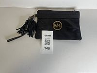 Front view showing MK logo, tassels, wrist strap and MaxSold tag