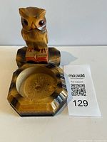 Front view of carved wooden owl ashtray showing owl, book, and bowl recess