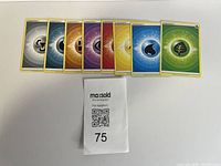 Fan arrangement of all eight Basic Energy cards with lot tag visible
