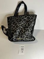 Front view showing leopard pattern, logo and tote handles