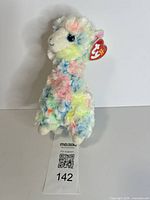 Front view of Lola the Llama plush with hang tag visible