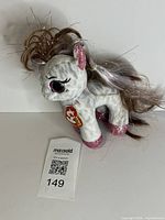 Front left view showing overall plush, hang tag visible