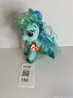 Front view of Ty Topaz plush showing tag and features