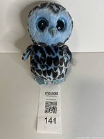 Front view of Yago owl plush showing full item