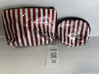 Both Victoria's Secret red/white stripe cosmetic bags front view