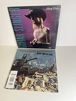 Front cover Johnny Winter Guitar Slinger and partial Joe Walsh album