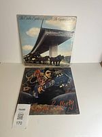 Two vinyl album covers stacked, lot overview