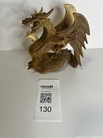 Front angled view showing full dragon carving