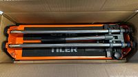 Tile cutter inside box showing compact form