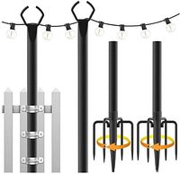 Front view of black metal poles, fence bracket assemblies, and ground spike anchors