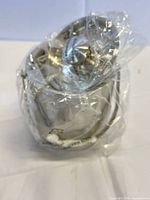 Ice bucket wrapped in plastic with lid visible