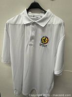 Front view of white Ferrari Club of America polo on hanger