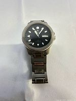 Front view showing dial, day-date window and bracelet