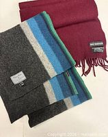 Both scarves laid flat showing colours and fringe