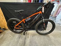 Full side view of Hyper electric mountain bike with saddle bag attached